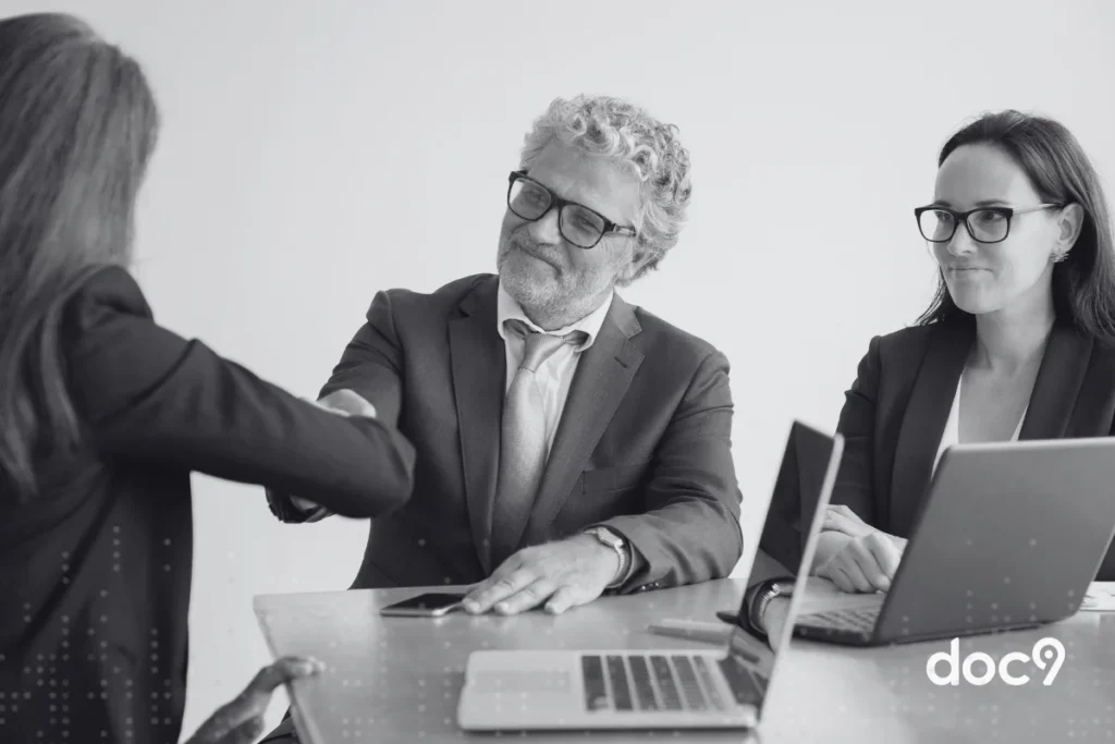 Rapaz apeerta a m&atilde;o de uma mo&ccedil;a, como se estivessem fechando um acordo, representando um artigo da doc9 sobre como captar clientes na advocacia.